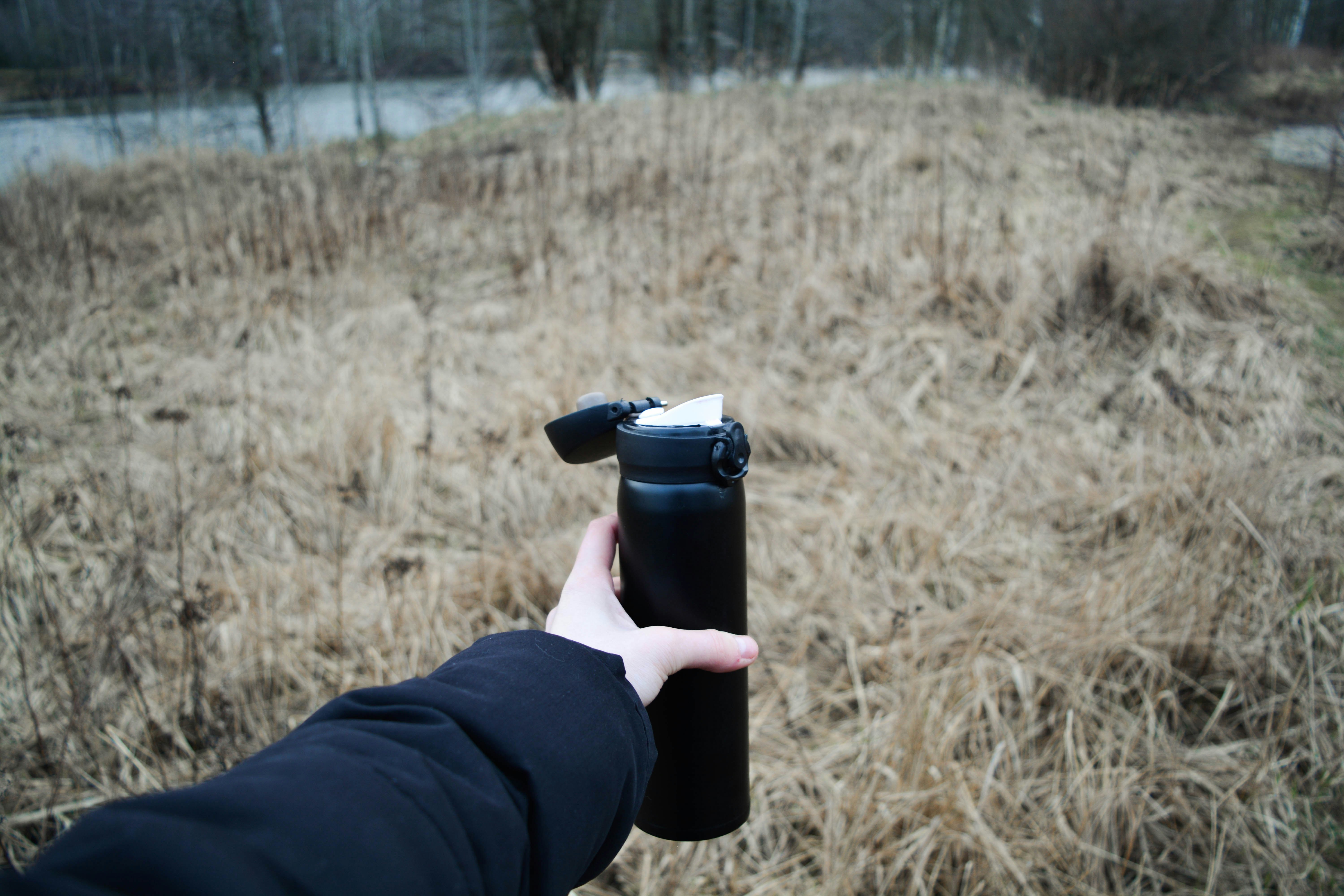 person holding black dslr camera